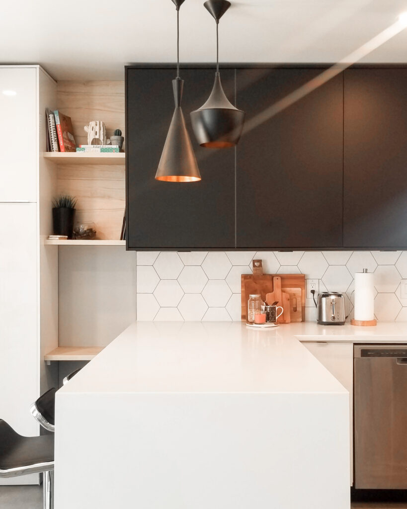 Black, white and wood tones kitchen with hexagon backsplash